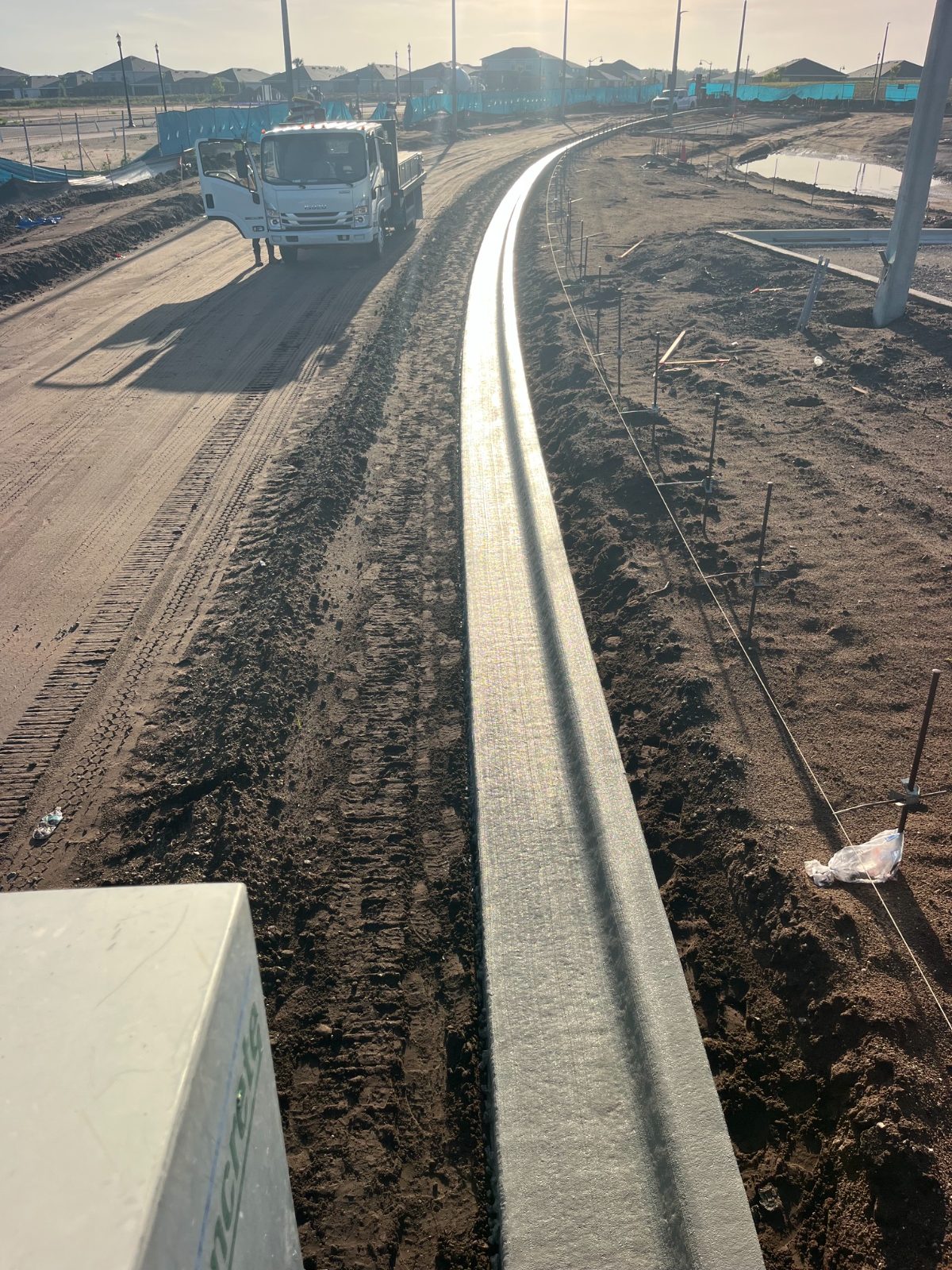 Machine curb run curving through a new residential subdivision in Sarasota, FL