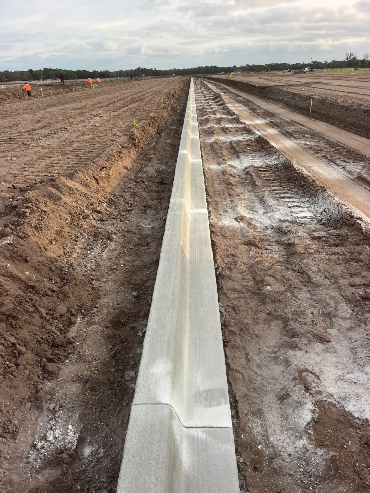 Long run of extruded concrete curb on a graded site in Manatee County, FL